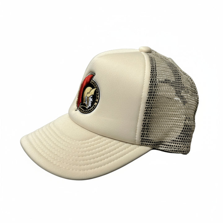 Beige cap with a black mesh back and logo on a white background