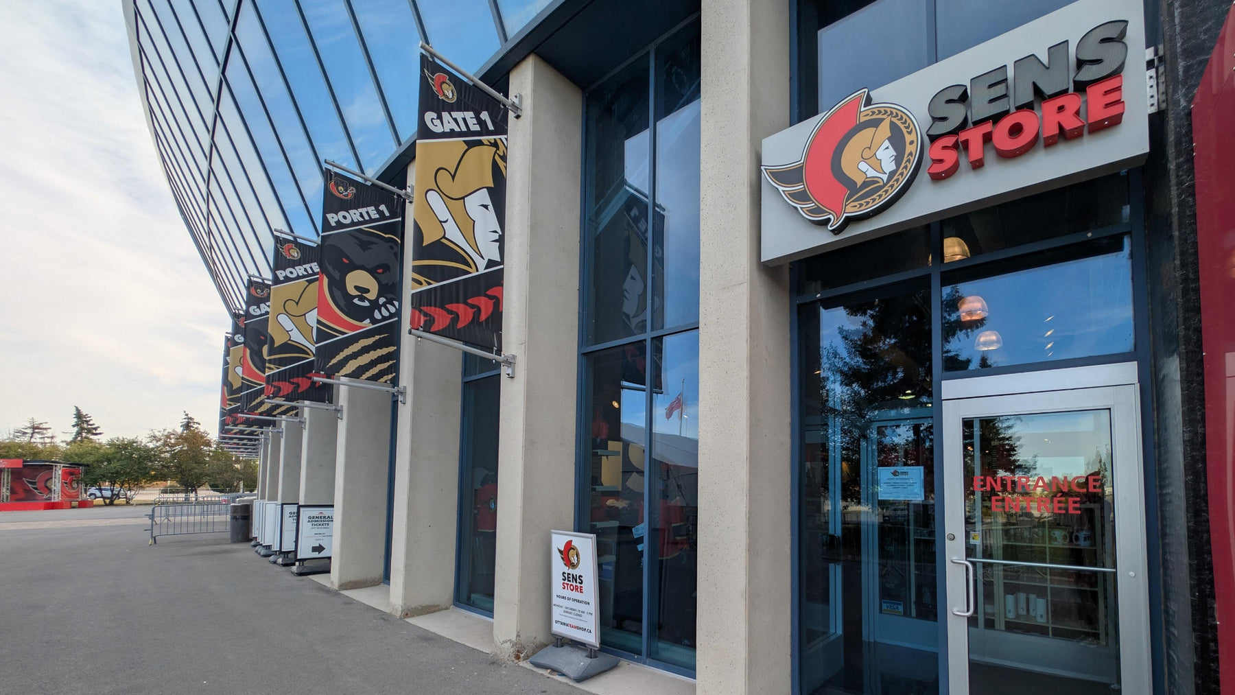 Sens Store entrance with hockey-themed flags outside a building